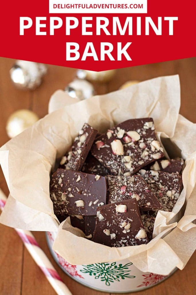 Pinterest pin showing an overhead shot of a tin full of peppermint bark, this image is to be used to pin this recipe to Pinterest.