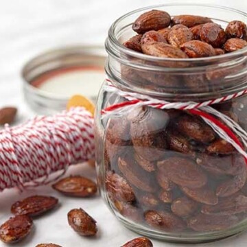 A jar of maple roasted almonds in a small mason jar.