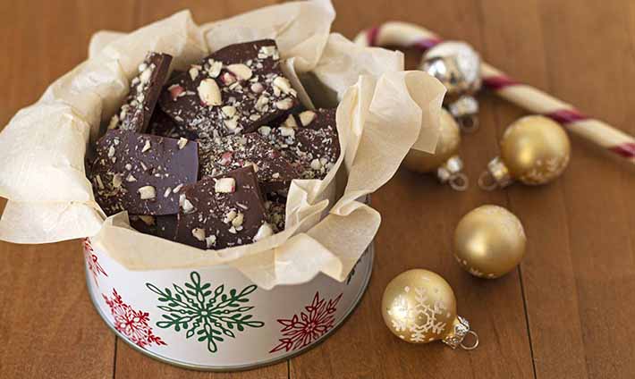 A holiday tin full of homemade chocolate peppermint bark.