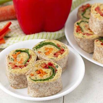 Three vegetable pinwheels on a small white plate.