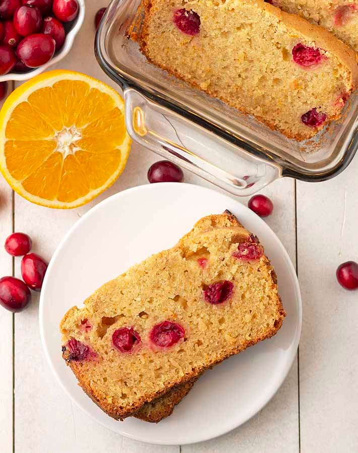 Overhead shot of vegan gluten free cranberry orange bread slices on a plate.