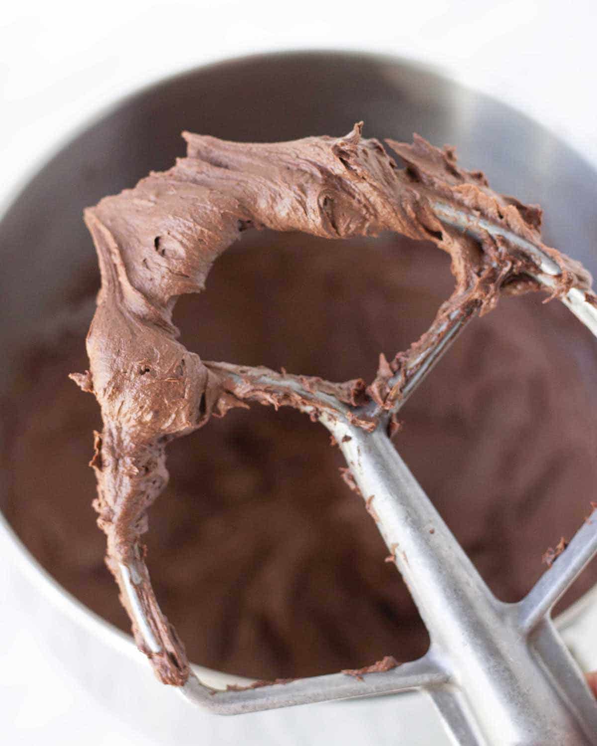 Dairy free chocolate buttercream on a stand mixer paddle attachment.