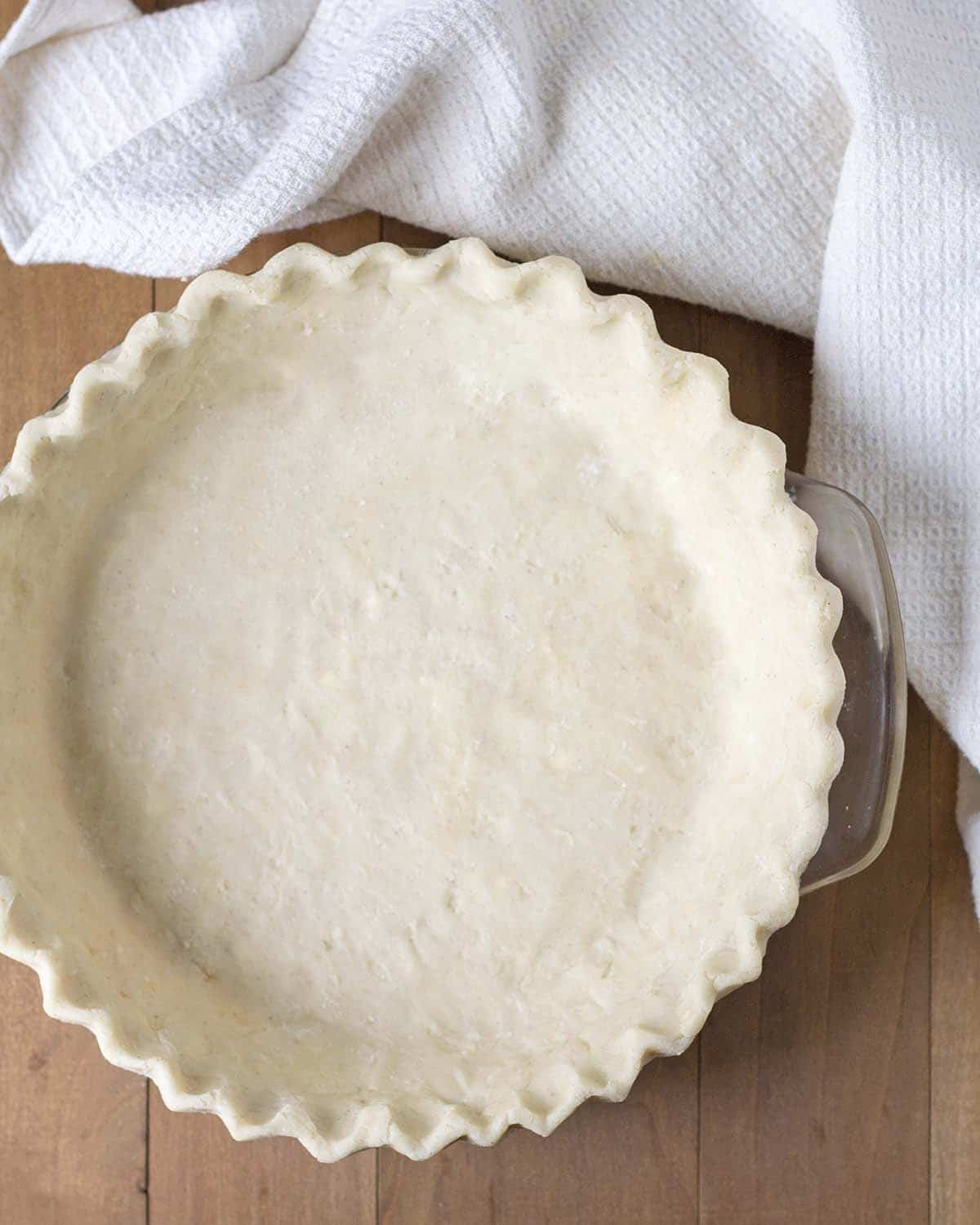 Overhead shot of a pie crust in a pie dish.