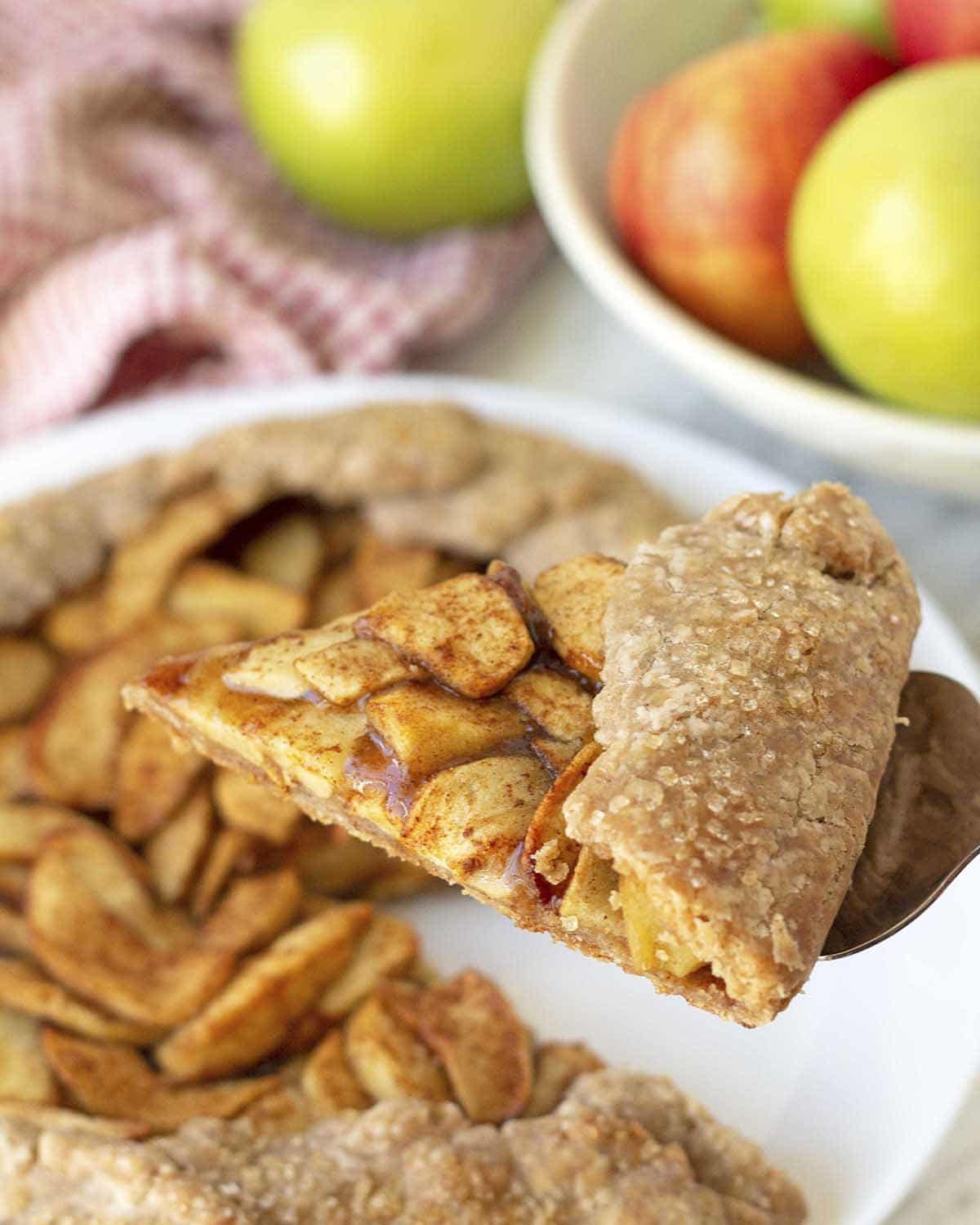 A slice of gluten-free apple galette on a pie server.