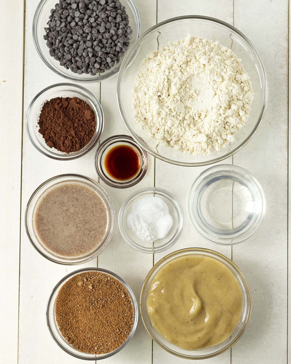 Overhead shot showing ingredients needed to make gluten free chocolate banana muffins, ingredients are in separate bowls.