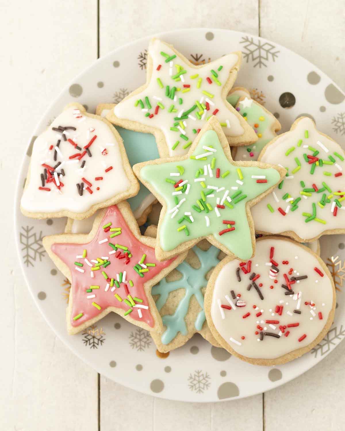 Overhead shot of decorated Christmas gluten free vegan cut out cookies on a plate.