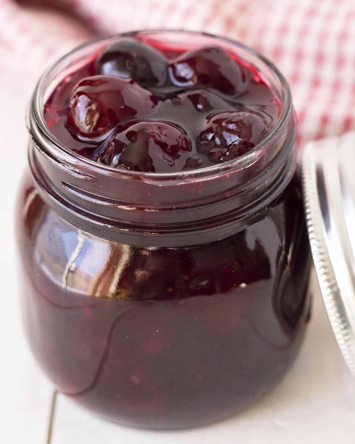 A mason jar filled with homemade cherry sauce.