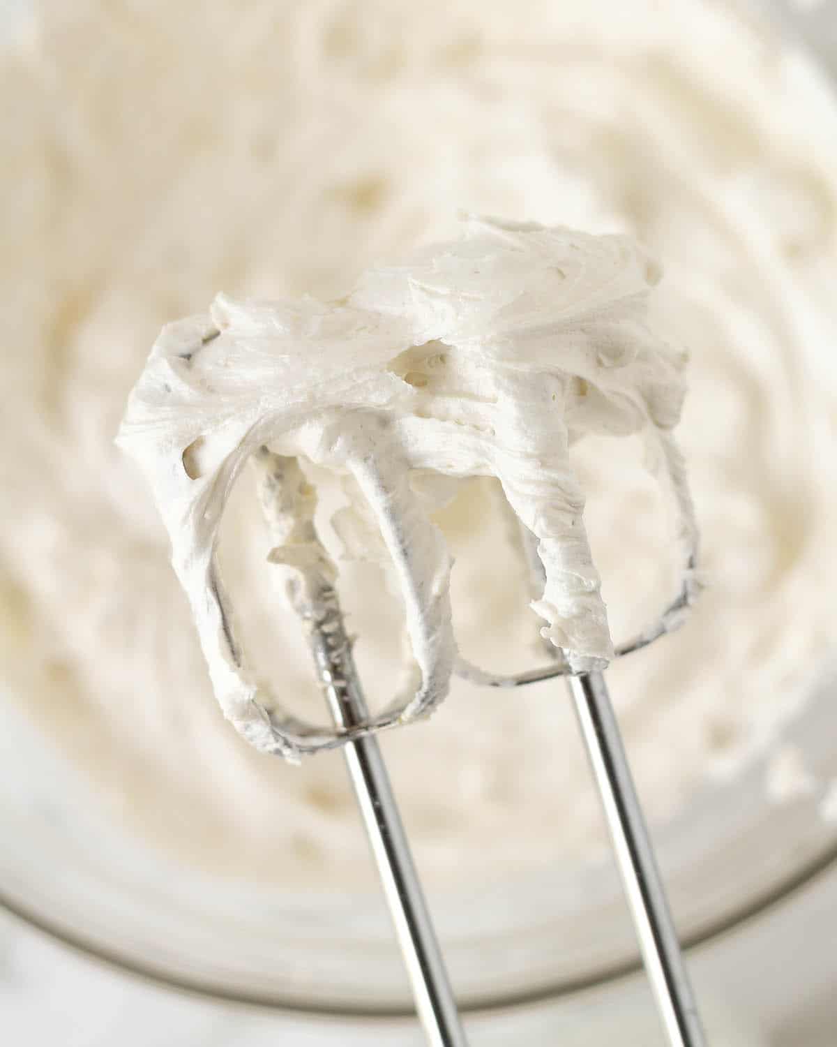Image shows lemon frosting on the beaters of an electric mixer.