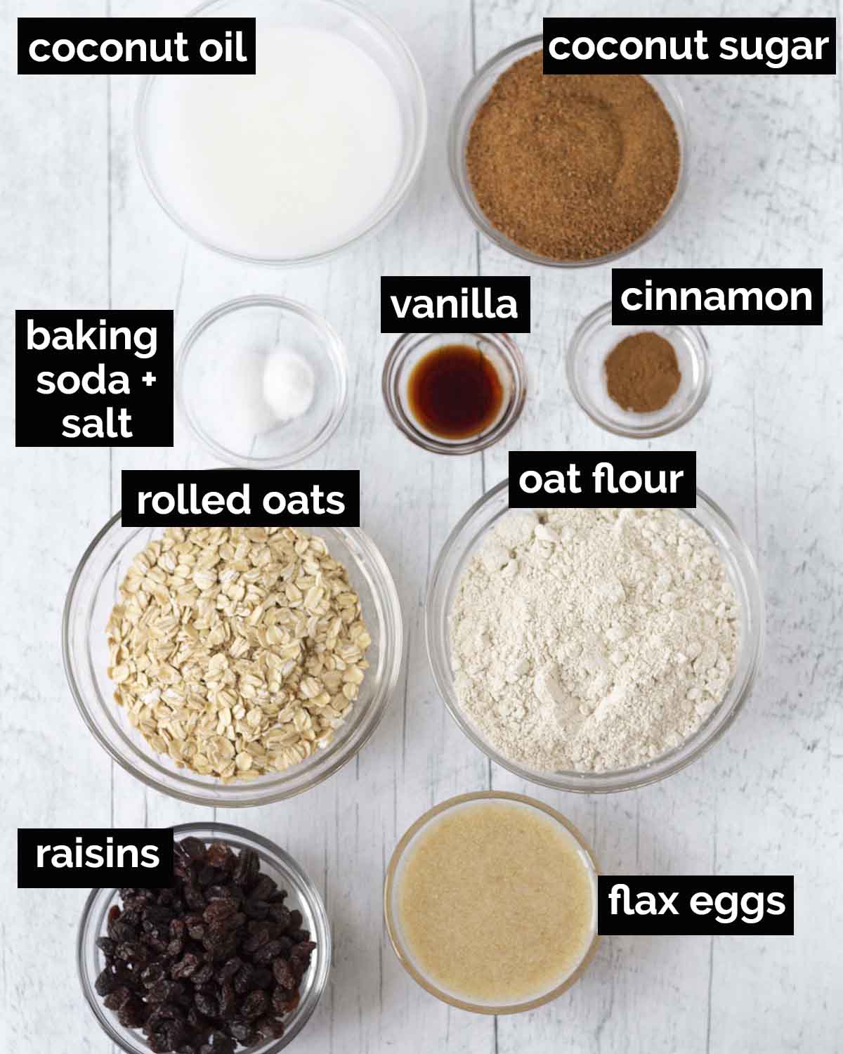 An overhead shot showing all the ingredients needed to make soft and chewy vegan oatmeal raisin cookies.