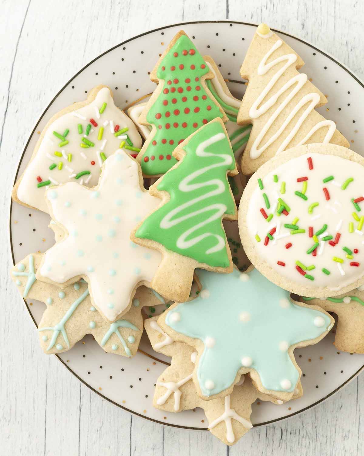 A plate of pretty Christmas cookies that have been decorated with aquafaba royal icing.