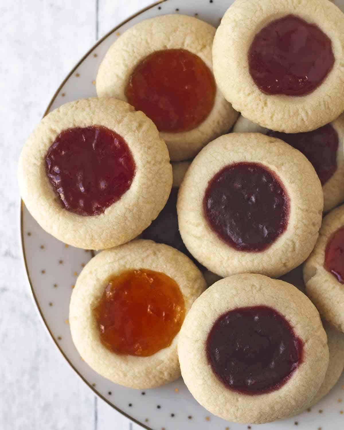 An overhead shot showing a plate full of vegan thumbprint cookies.