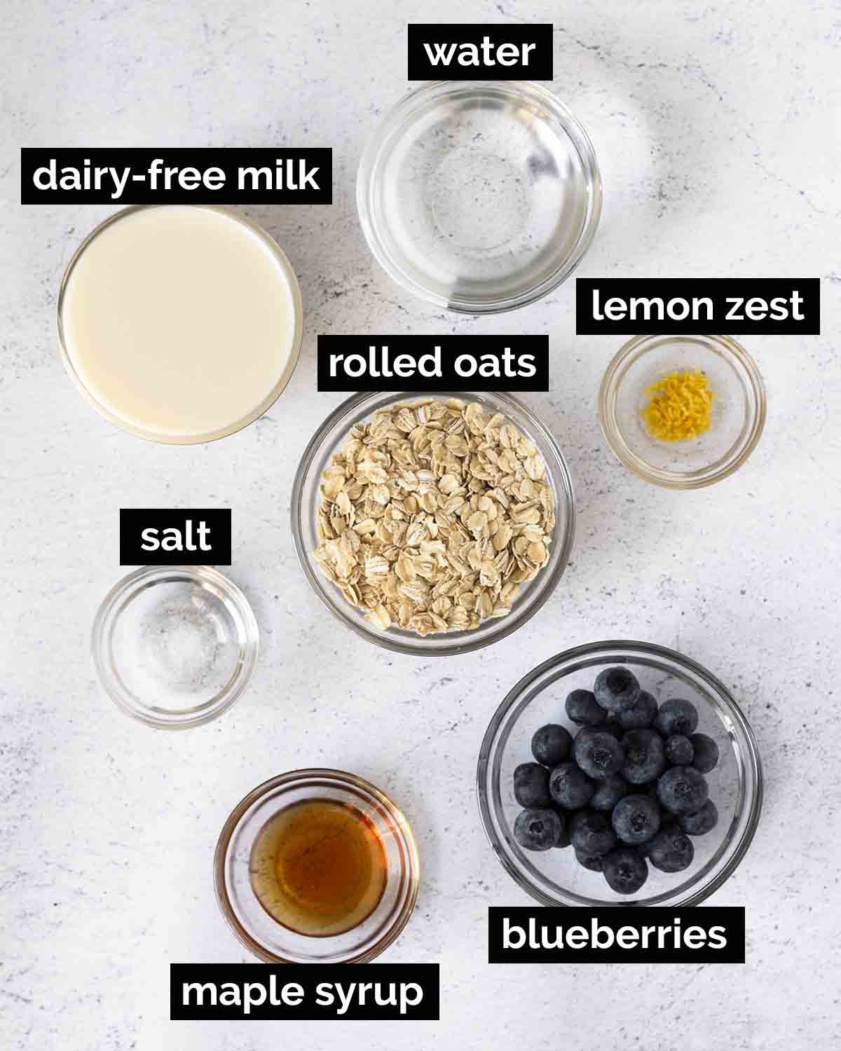 An overhead shot showing the ingredients needed to make blueberry oatmeal.