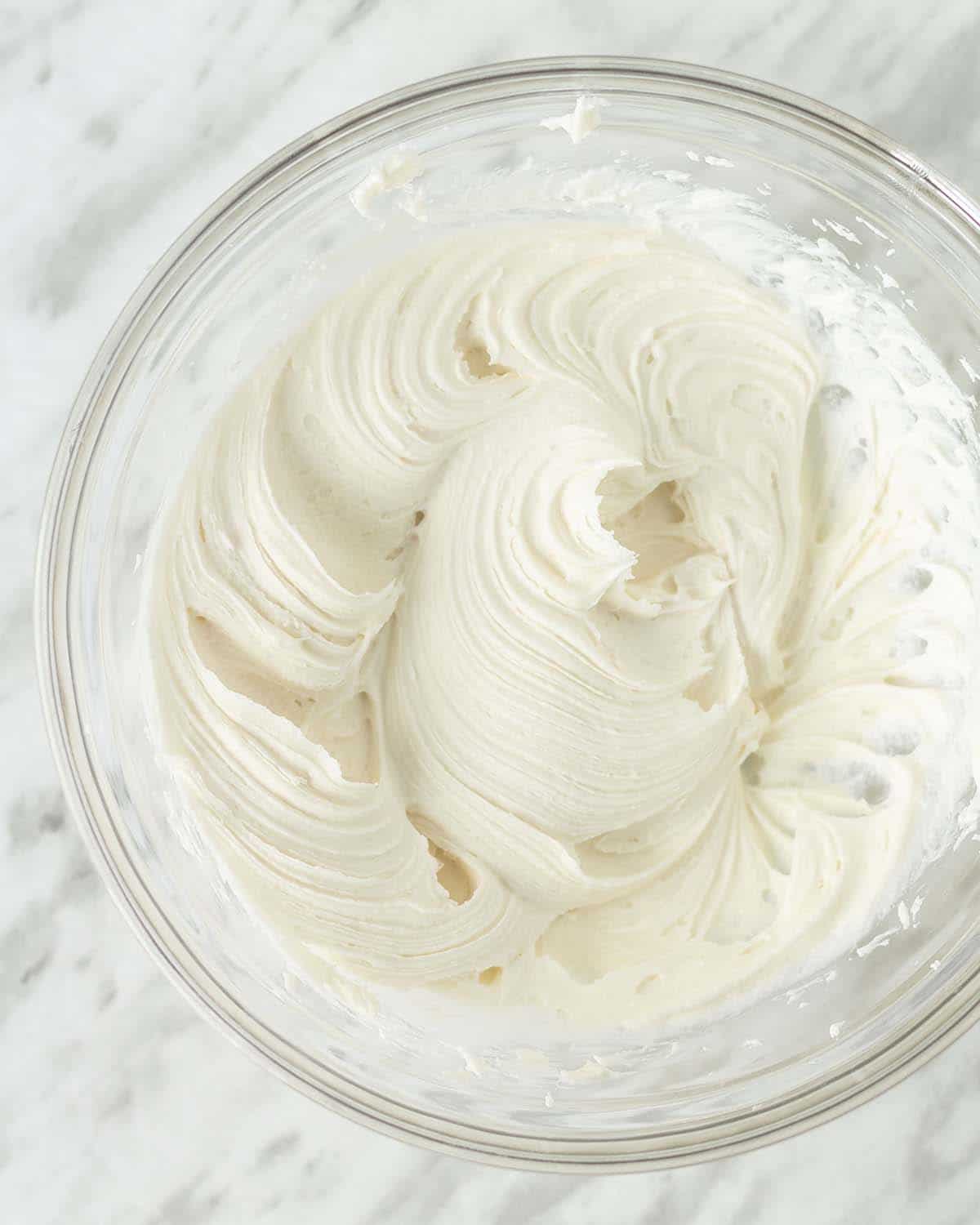 An overhead shot showing a bowl of freshly made vegan cream cheese icing.