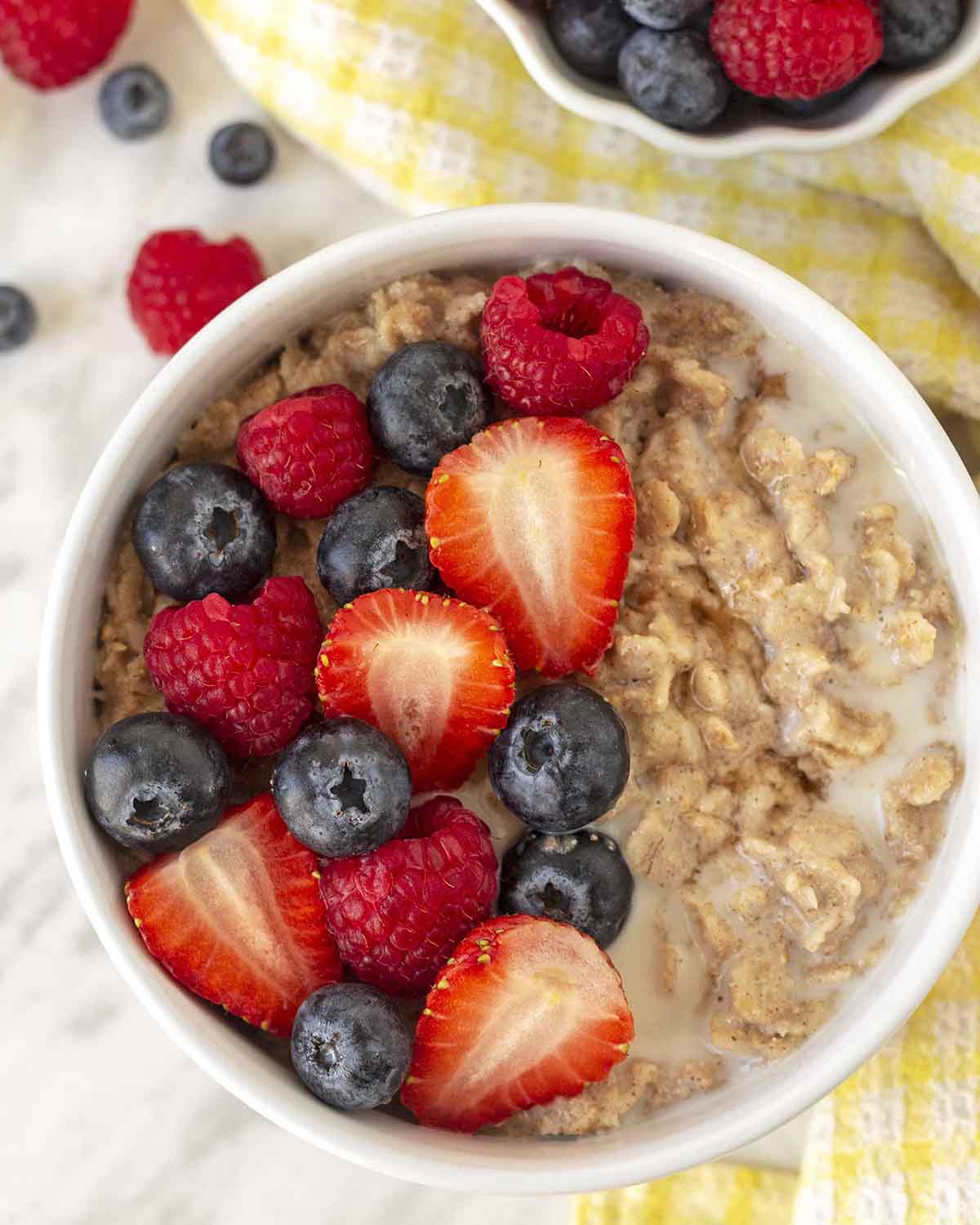 An overhead shot showing a bowl of flax oatmeal topped with fresh berries.