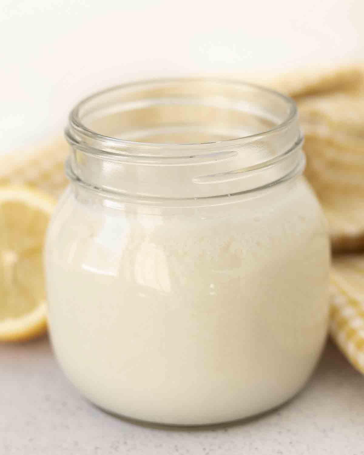 A small jar filled with vegan buttermilk made with almond milk.