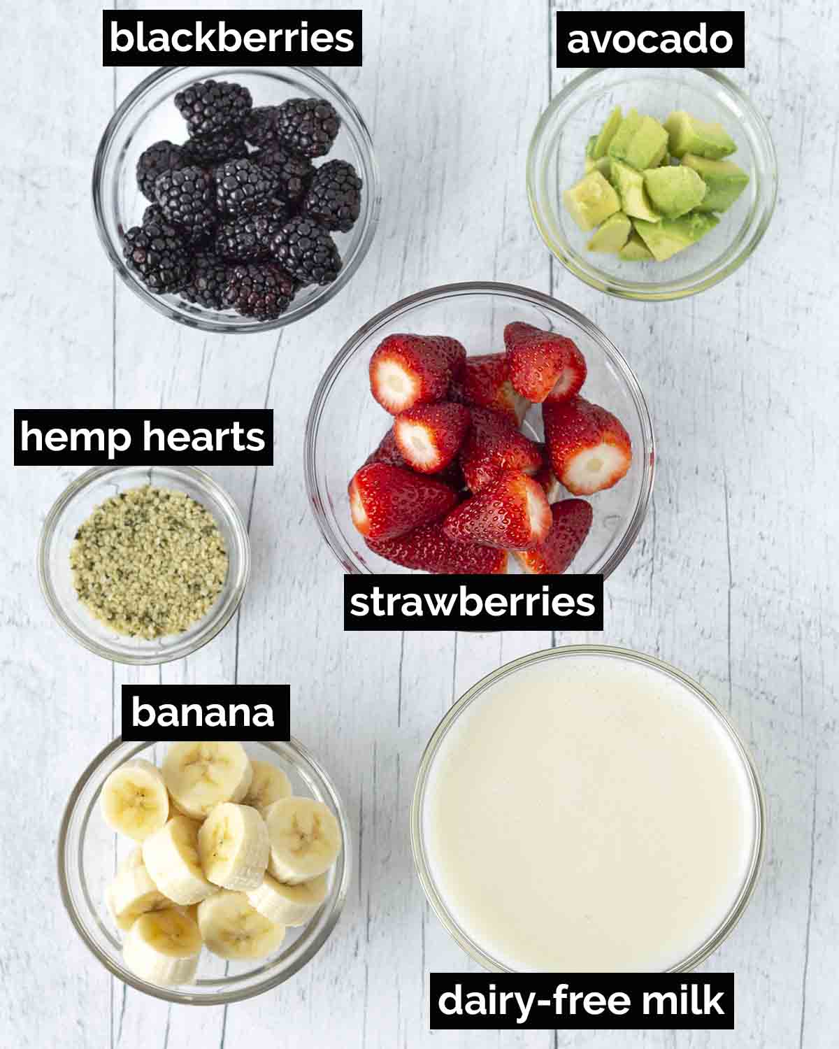 An overhead shot showing the ingredients needed to make a strawberry blackberry banana smoothie.