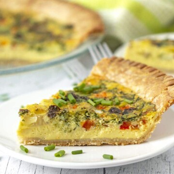 A slice of Just Egg quiche sitting on a small white plate.