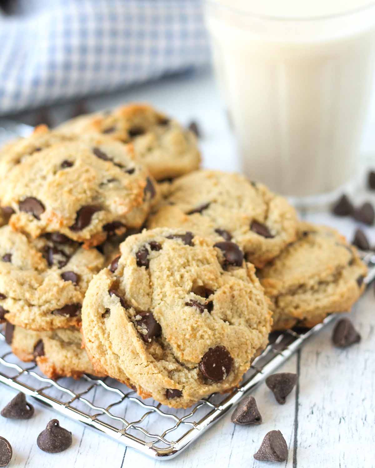 Almond flour chocolate chip cookies stacked on a cooling rack.