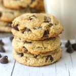 A stack of three chocolate chip cookies made with almond flour sitting on a table.