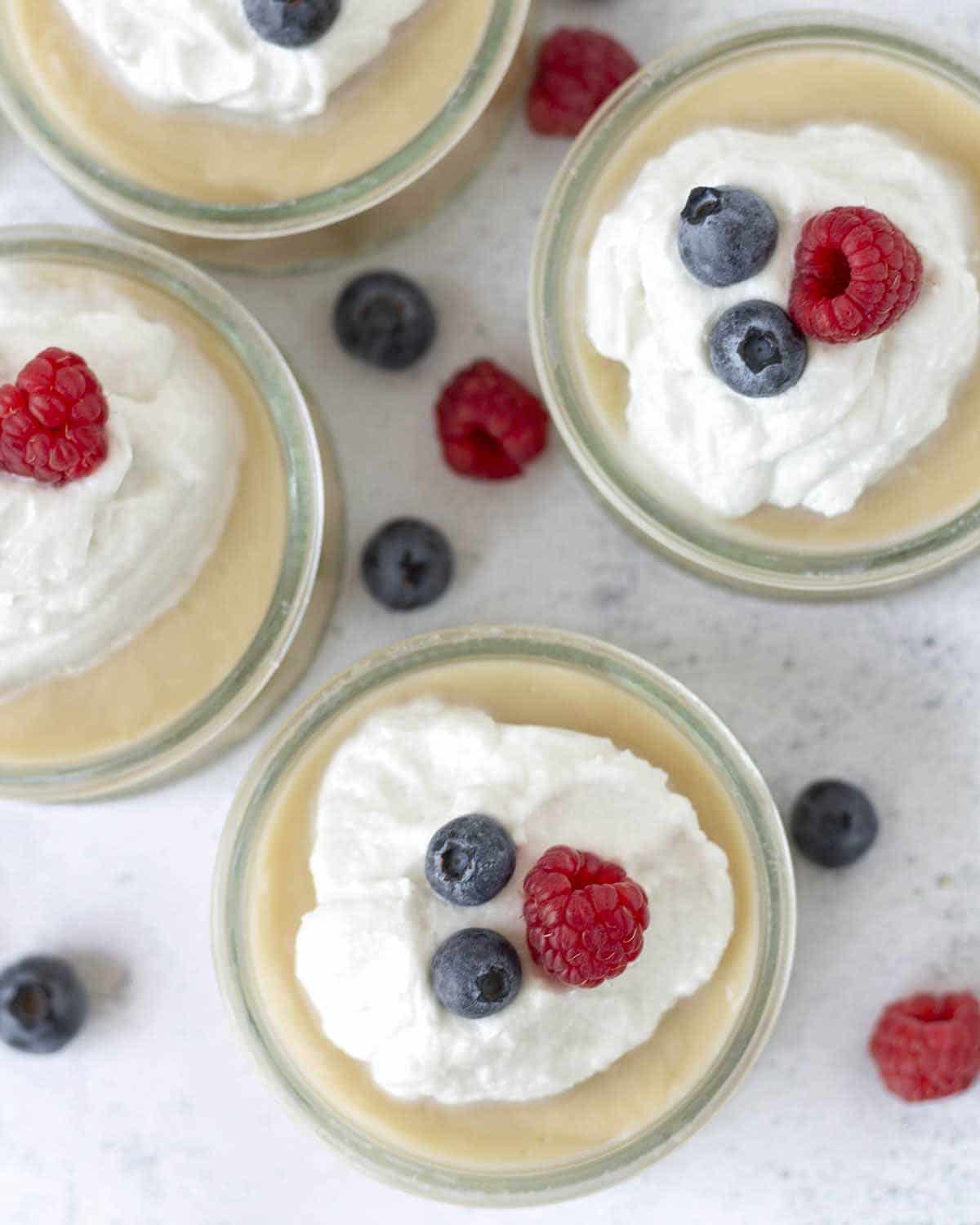 An overhead shot showing four bowls of dairy-free vanilla pudding.