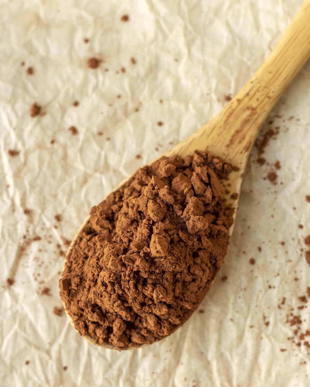 Cocoa powder in a wood spoon.