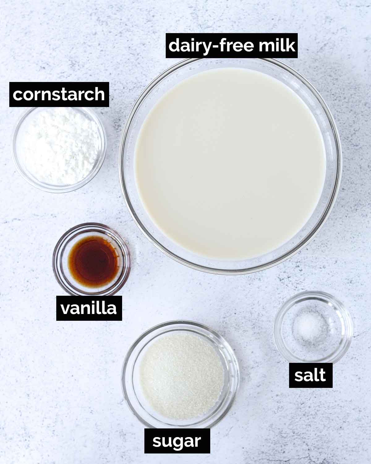 An overhead shot showing the ingredients needed to make vegan vanilla pudding.