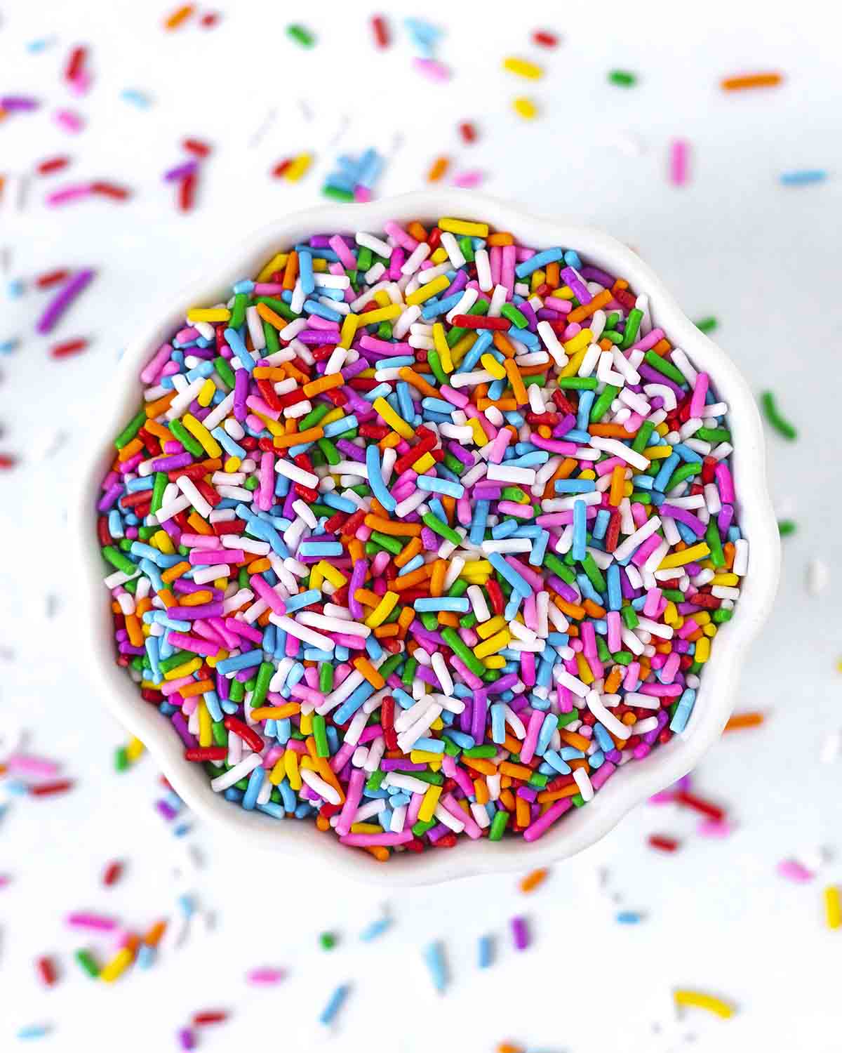 Cake sprinkles in a white bowl.