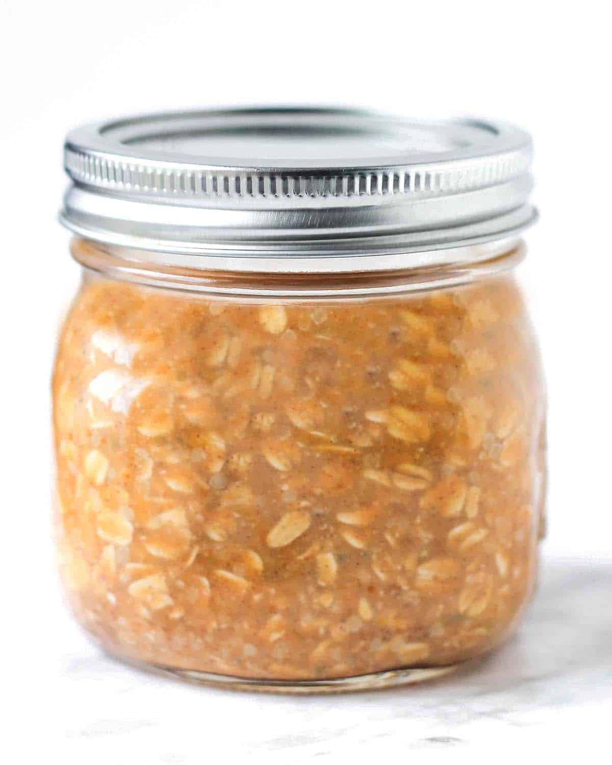 A closed mason jar filled with pumpkin spice overnight oats.