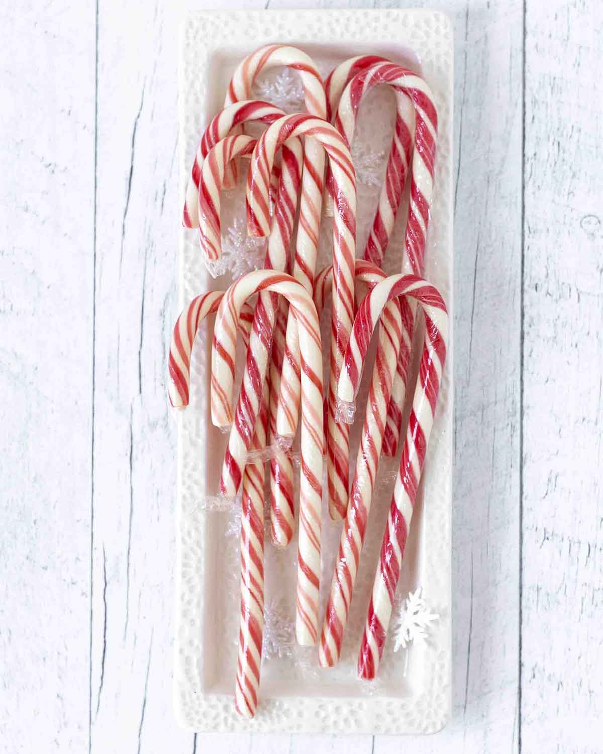 An overhead shot showing candy canes in a white rectangular plate.