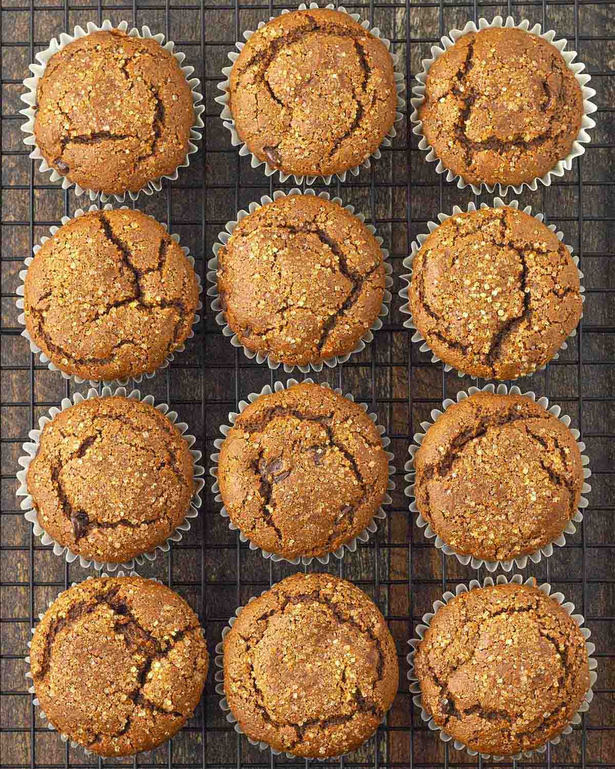 Freshly baked gingerbread muffins on a cooling rack.
