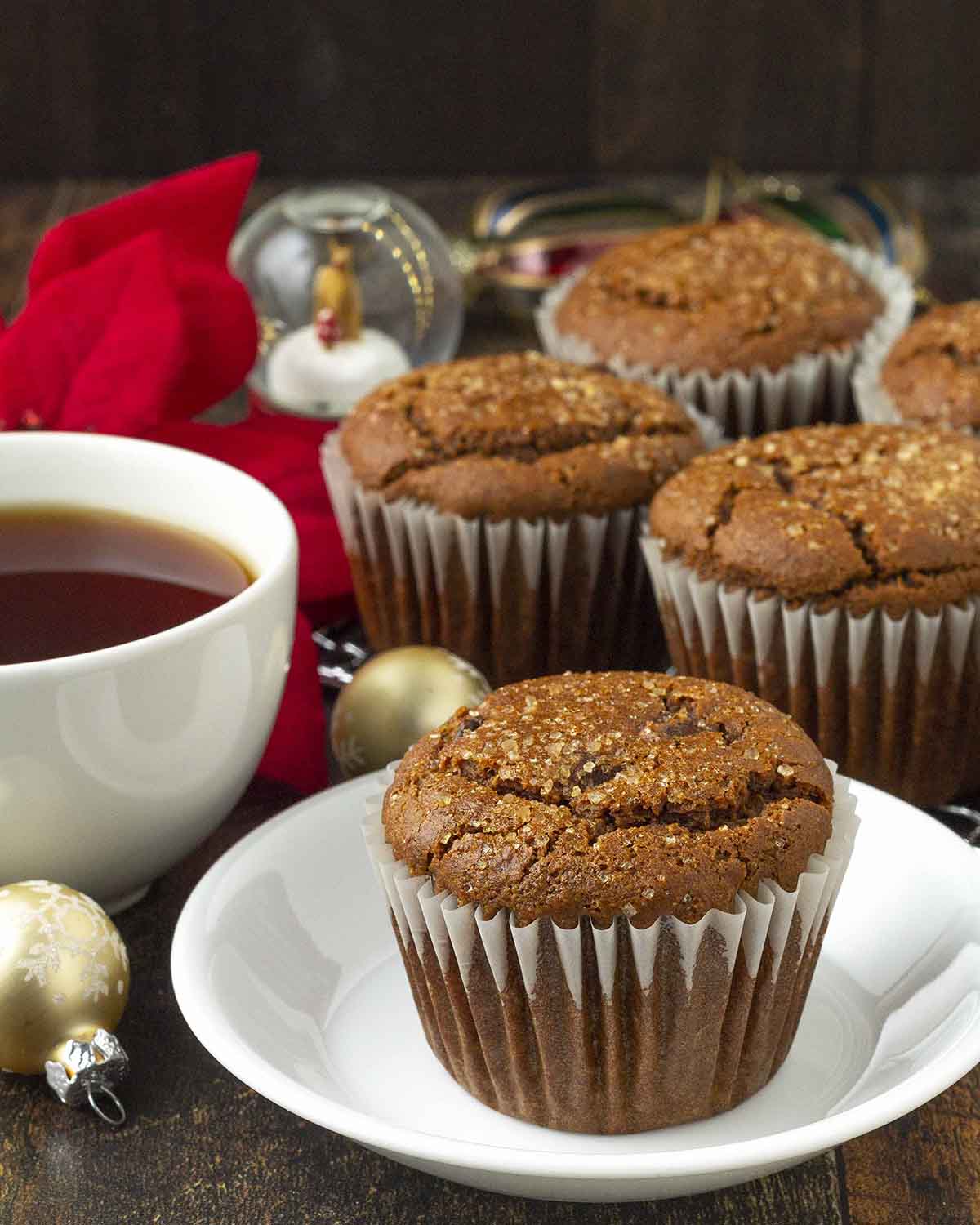 A vegan gluten-free gingerbread muffin on a small white plate.
