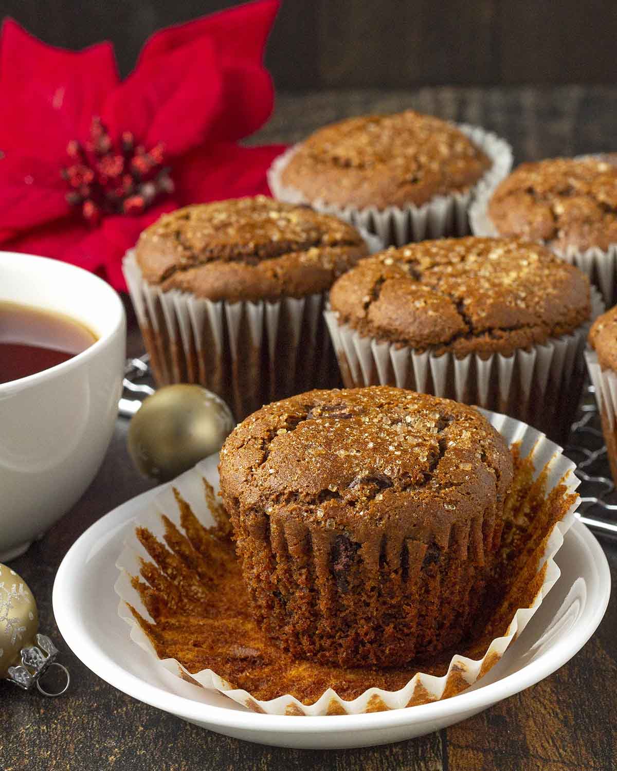 A gingerbread muffin on a plate, the muffin wrapper has been peeled away.