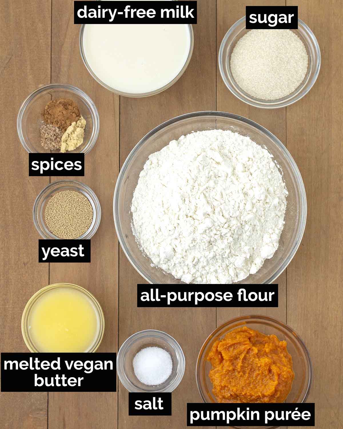 An overhead shot showing the ingredients needed to make vegan pumpkin cinnamon rolls.