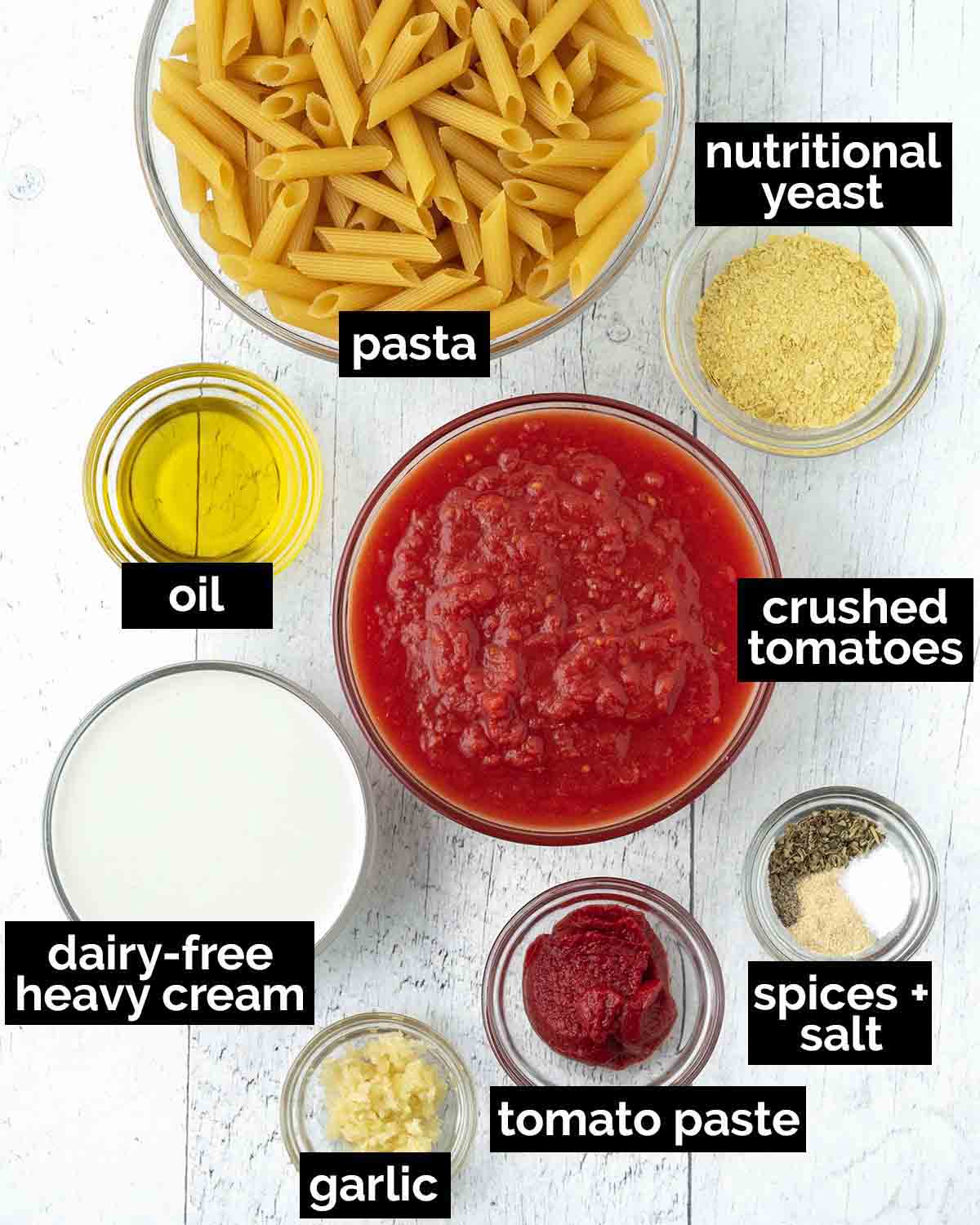 An overhead shot showing the ingredients needed to make vegan tomato pasta.