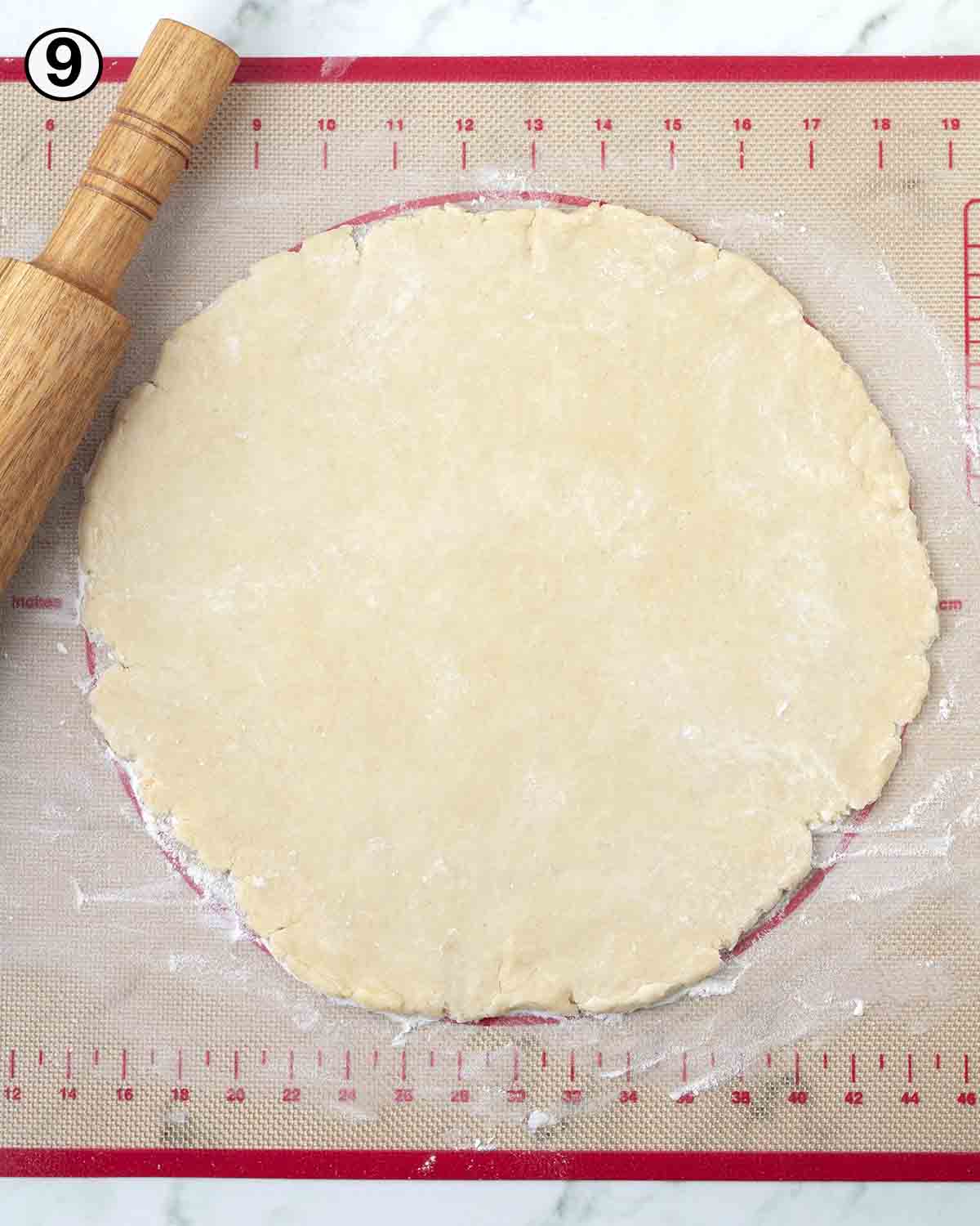 Vegan pie dough rolled out on a pastry mat.