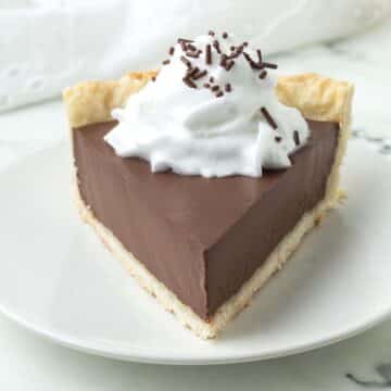 A slice of vegan chocolate pie sitting on a white plate.