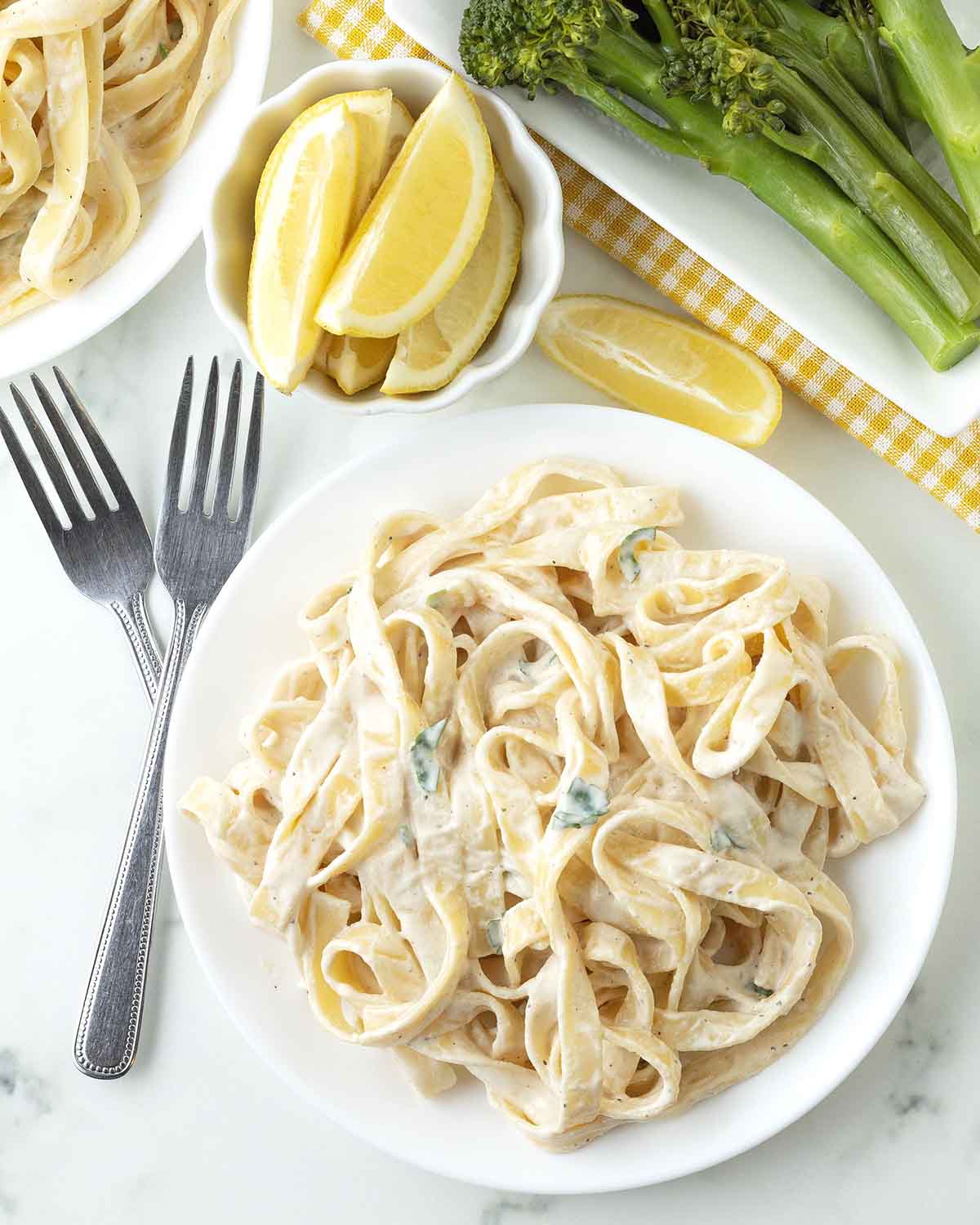 An overhead image of tahini pasta on a white plate.