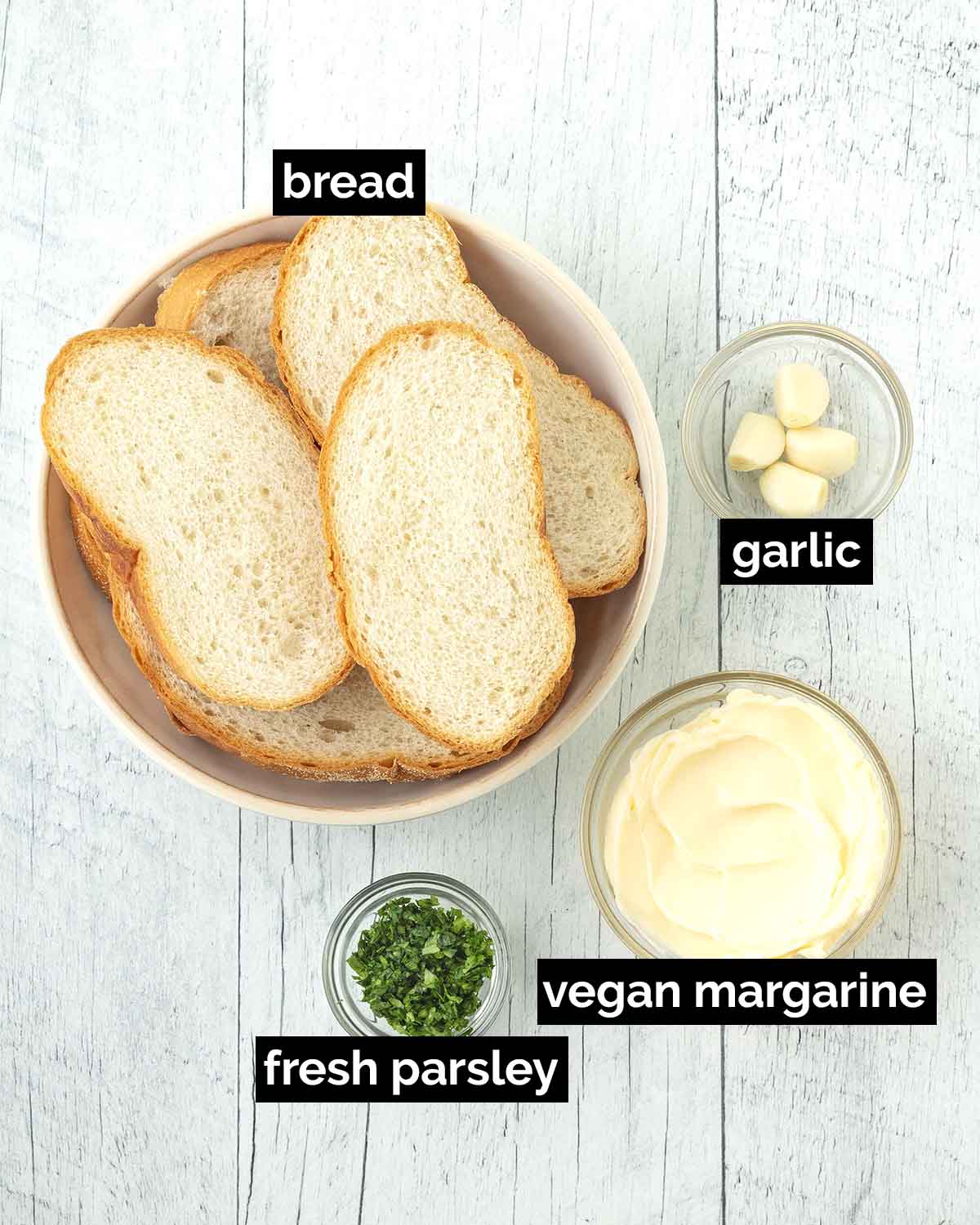 An overhead image showing the ingredients needed to make vegan garlic bread.