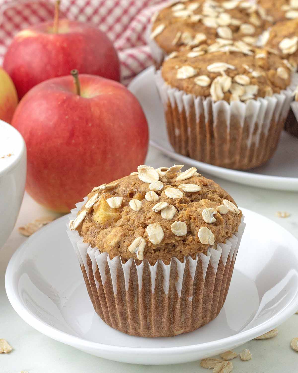 An apple oatmeal muffin on a small white plate.