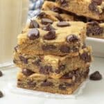 A close up of a stack of chocolate chip cookie bars.