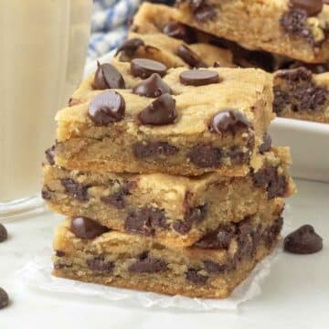 A close up of a stack of chocolate chip cookie bars.