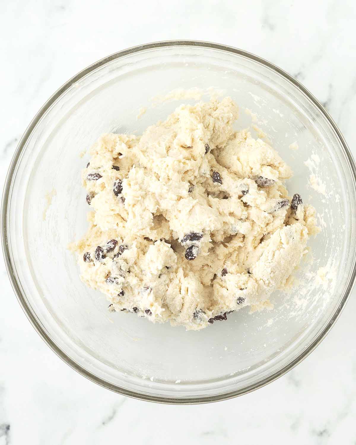 Mixed dough for scones in a glass bowl.