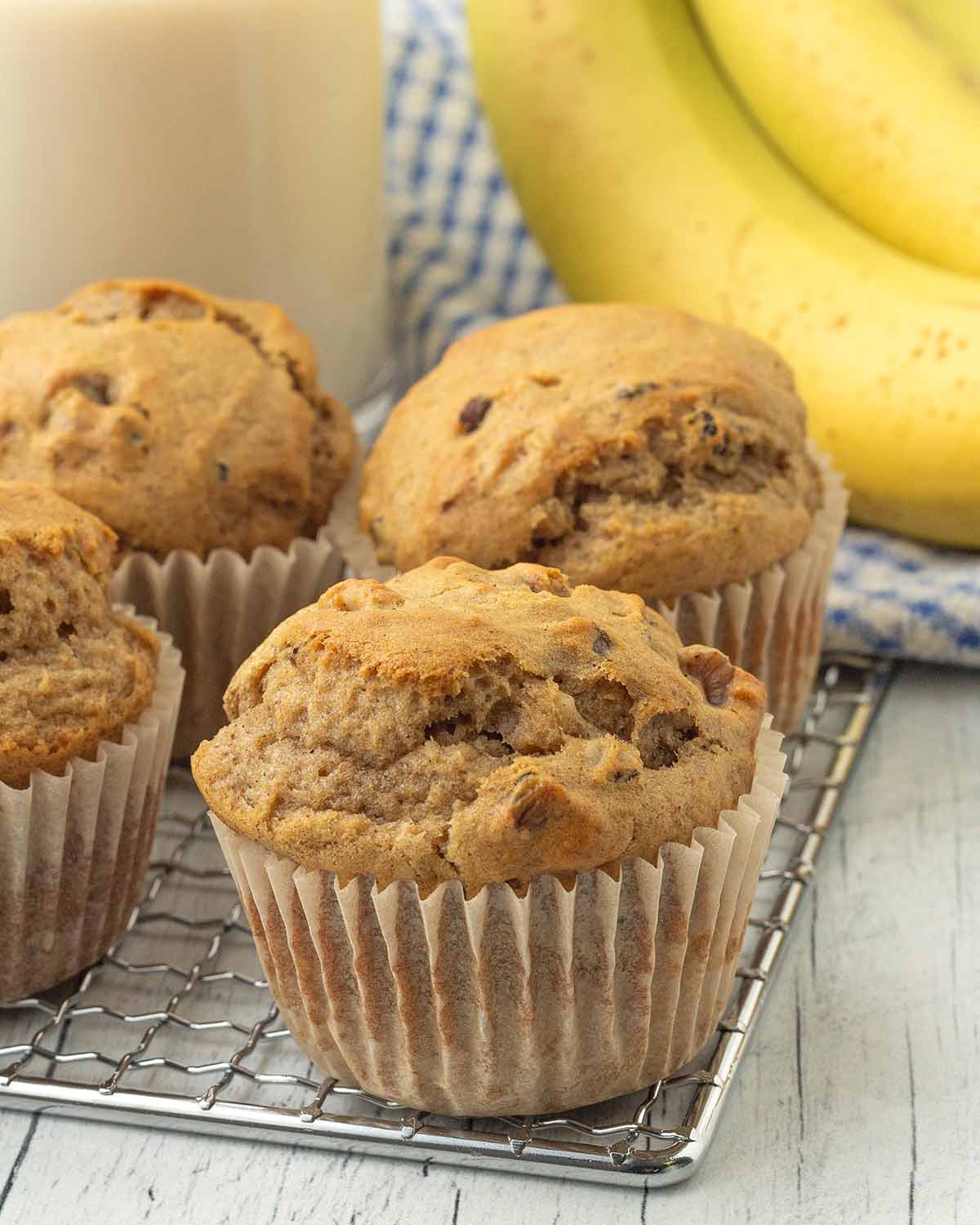 Muffins sitting on a metal rack.