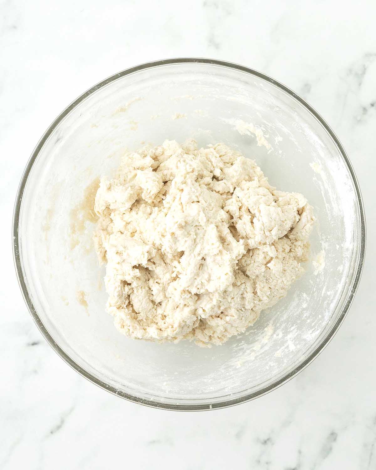 Biscuit dough in a glass bowl.