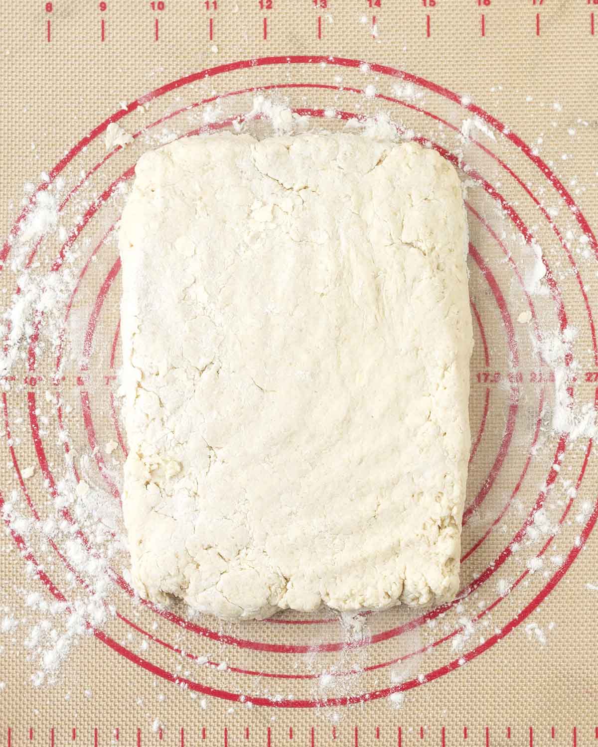 Biscuit dough flattened out into a rectangle.