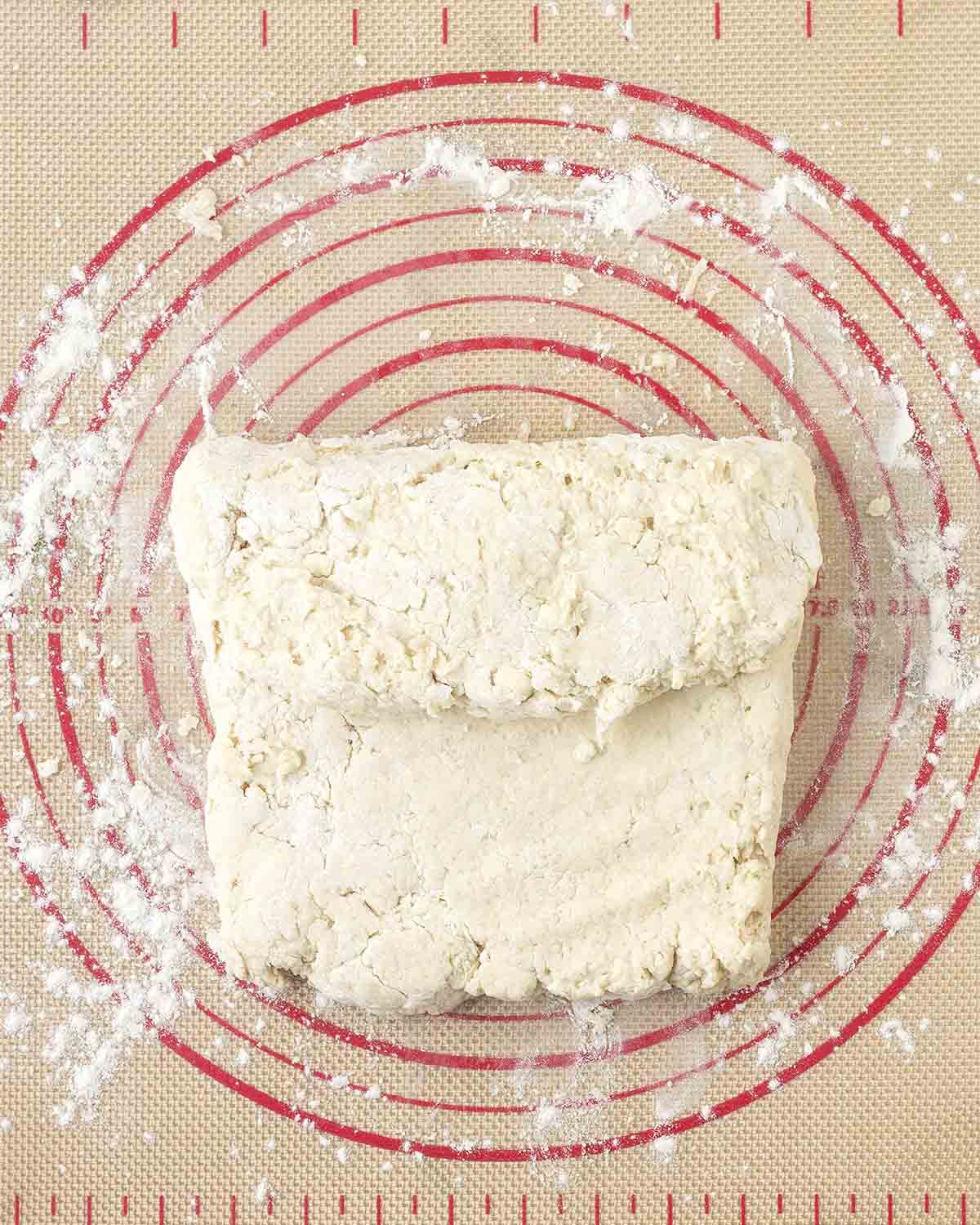 Biscuit dough folded one third of the way down onto itself to begin the lamination process.