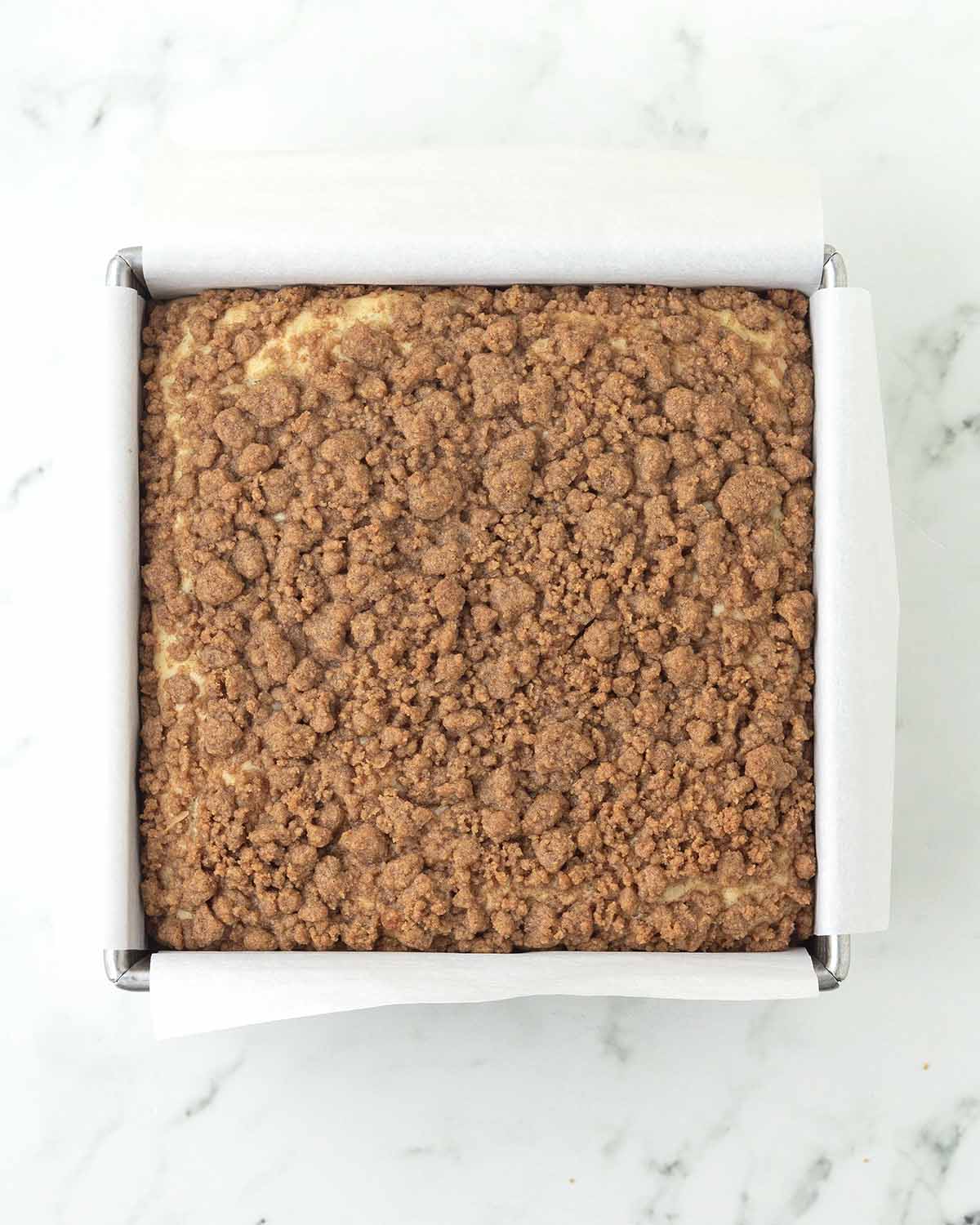 A baked coffee cake still in its baking pan.
