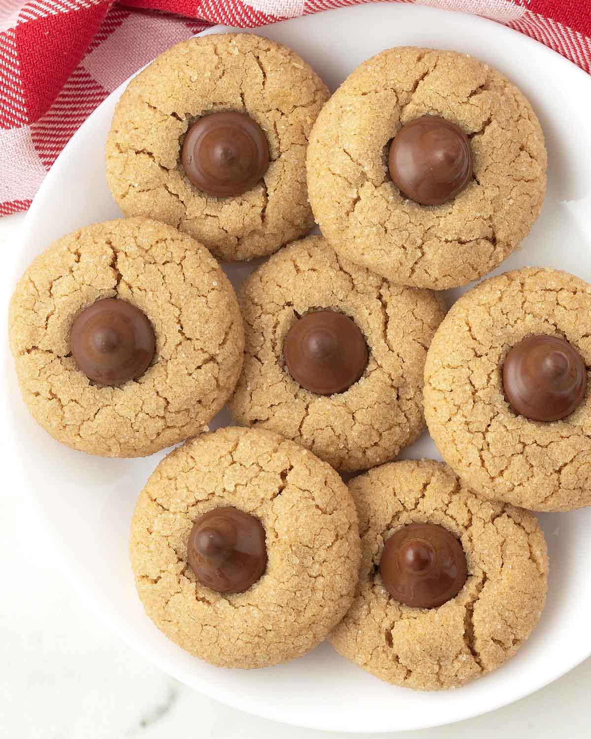 An overhead image of peanut butter blossoms on a plate.