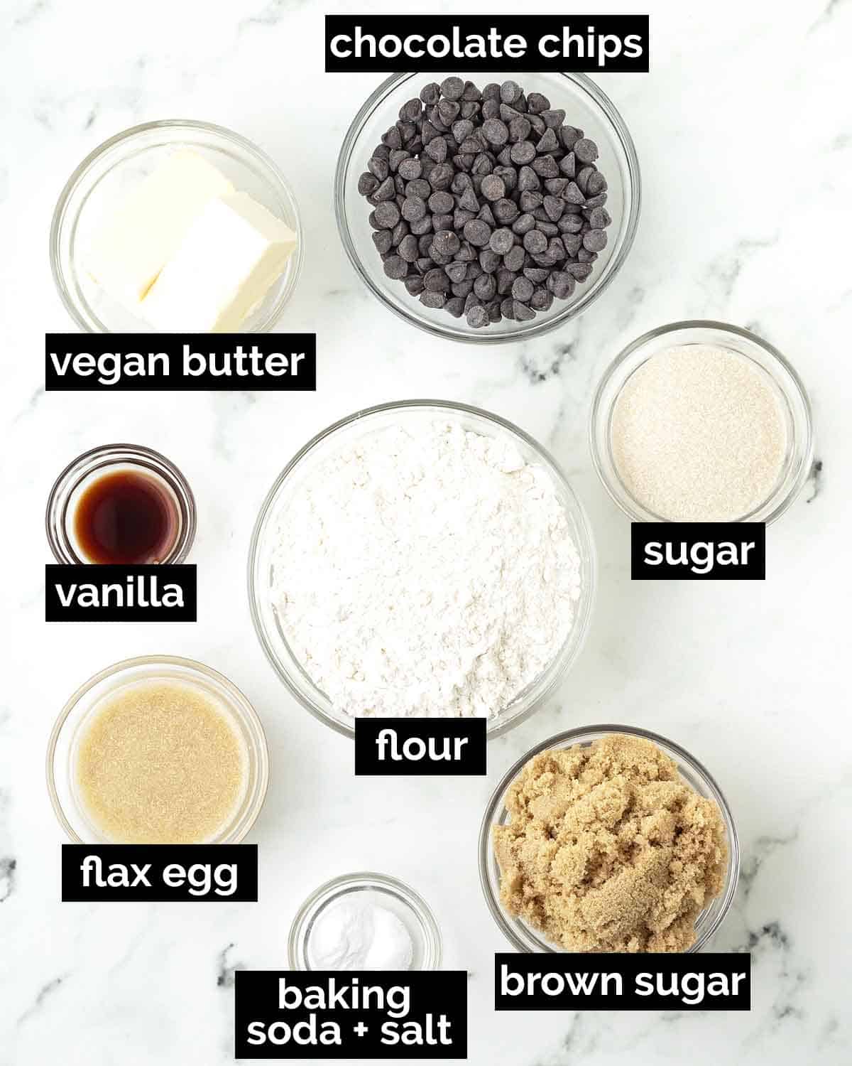 An overhead image showing the ingredients needed to make vegan chocolate chip cookies.