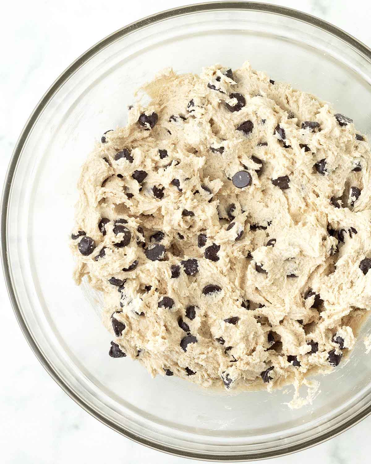 Mixed vegan chocolate chip cookie dough in a bowl.